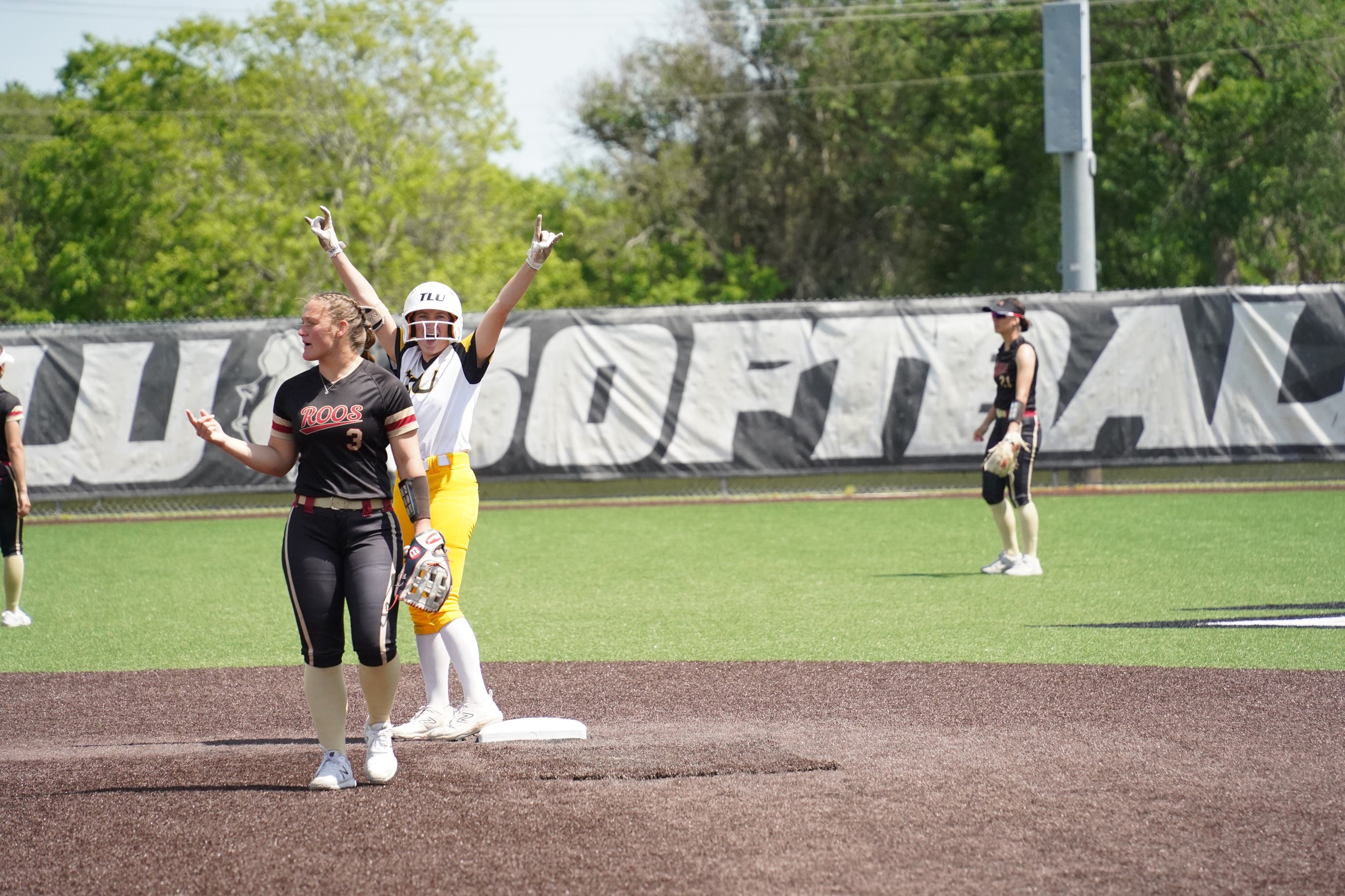 Caelee Clark celebrates at second base (photo by Bryce Hayes)