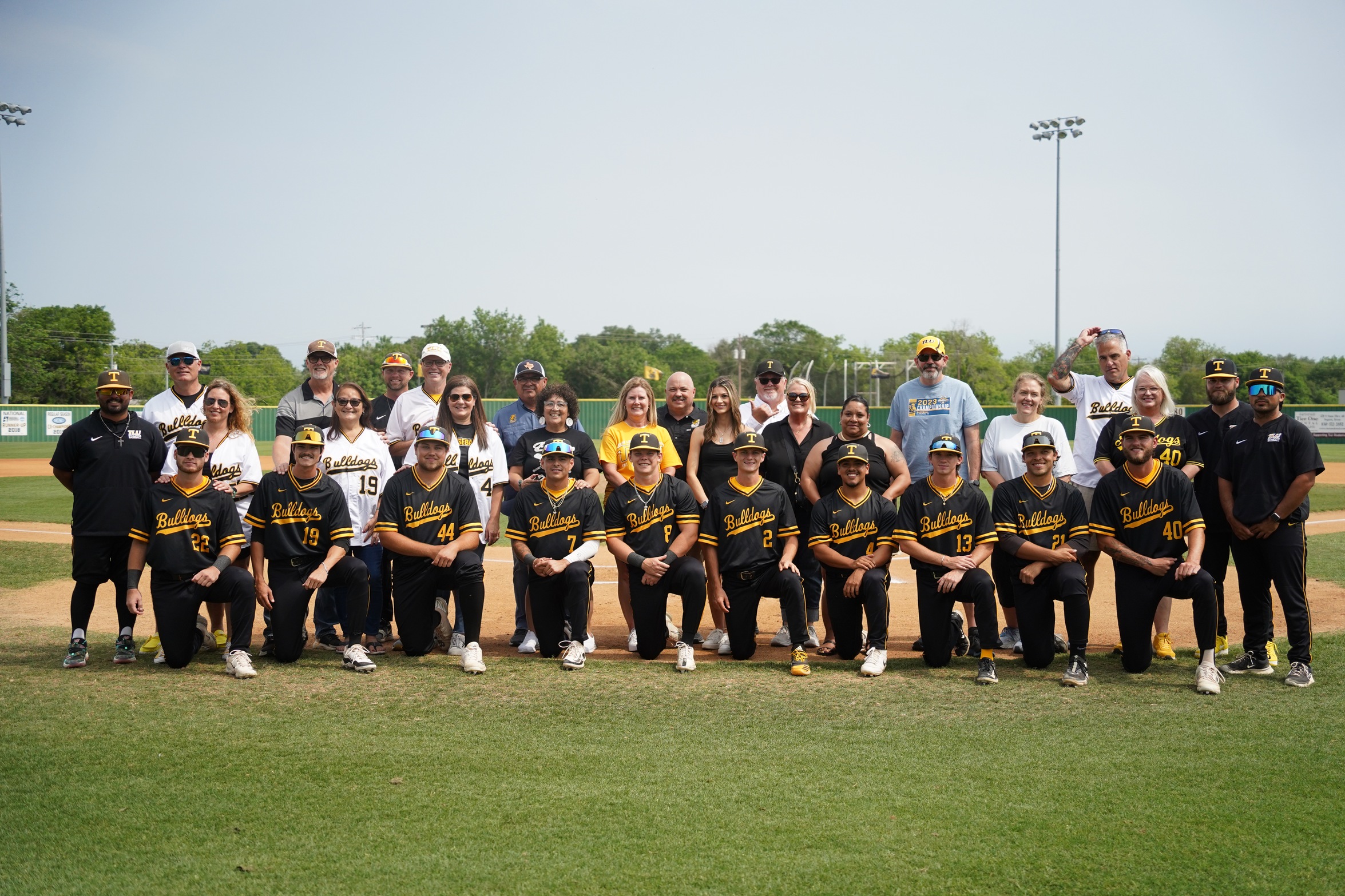 TLU Baseball seniors with their families and the. TLU Baseball staff (photo by Charleigh Phipps '25)