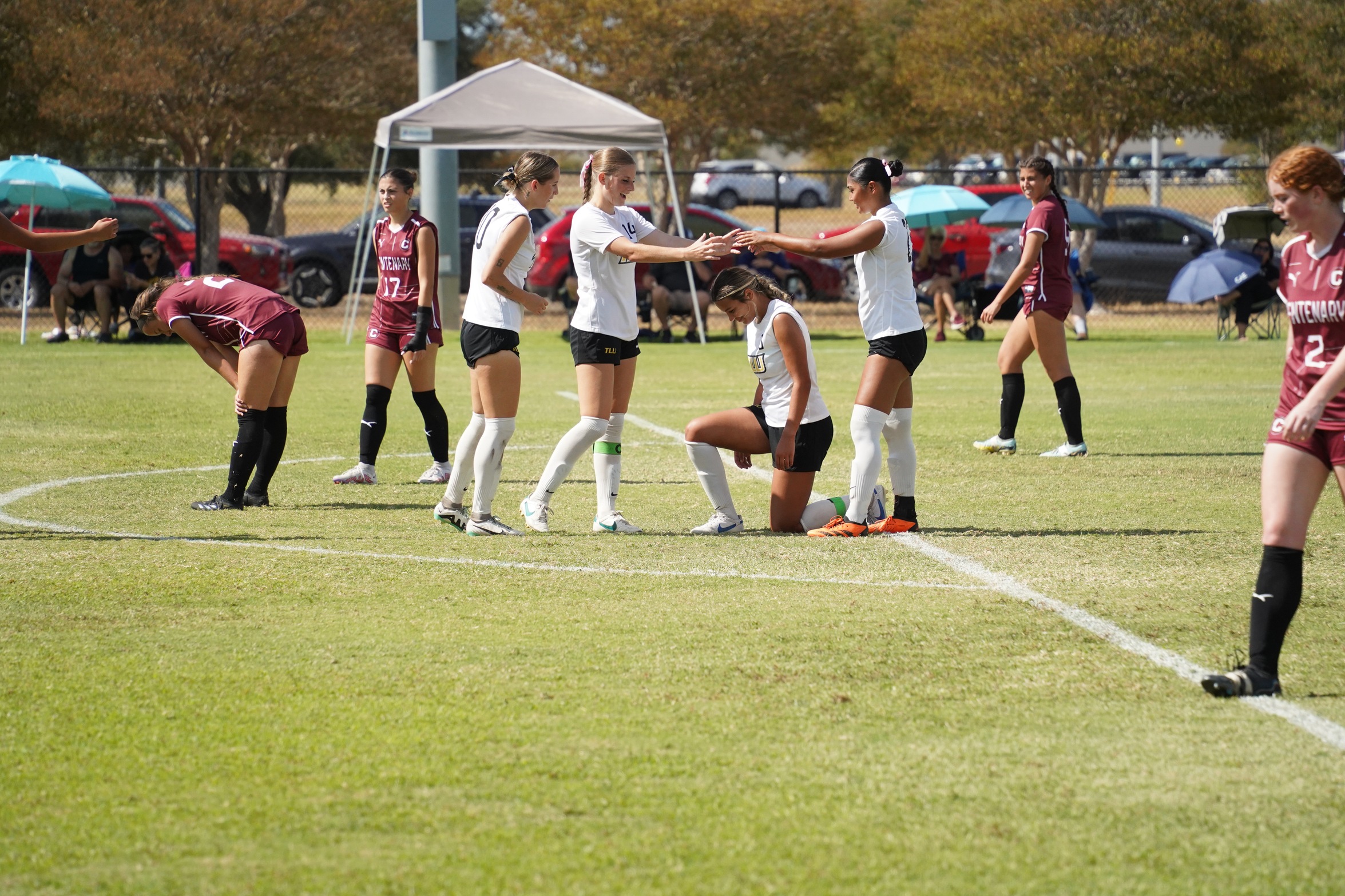 Alyssa Simien (kneeling) celebrates with her teammates (photo by Bryce Hayes)